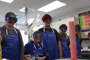 YMCA Academy students observing a lab demonstration in science class