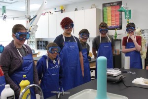 YMCA Academy students observing a lab demonstration in science class