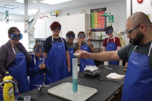 YMCA Academy students observing a lab demonstration in science class