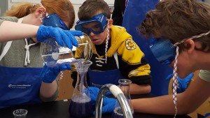 Students testing everyday substances to determine whether they are acids or bases in the science lab.