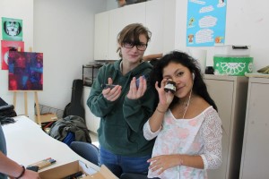 YMCA Academy students holding art equipment