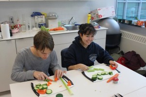 YMCA Academy students cutting vegetables during cooking club.