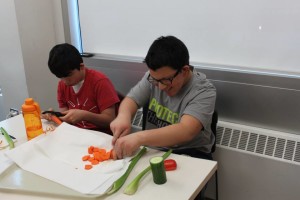 YMCA Academy students cutting vegetables during cooking club.