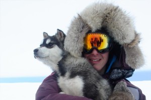 YMCA Academy student holds a baby husky