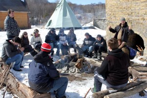 YMCA Academy students at a campfire in the winter at Evergreen Brick Works