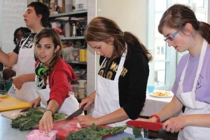 YMCA Academy students chopping kale at Shovel and Spoon