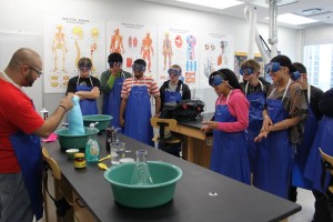 YMCA Academy students observing a lab demonstration in science class