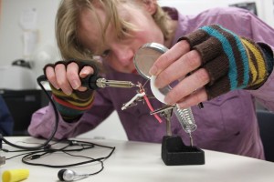 YMCA Academy student soldering wire