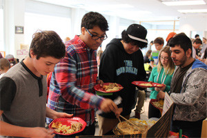 YMCA Academy students choosing buffet options at the school's annual Feast of Thanks