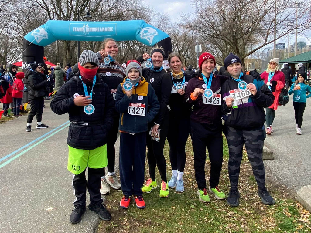 n November 30, the YMCA Academy Run Club, joined by friends and family (and even Tim!), participated in the Team Unbreakable Bold and Cold 5K.